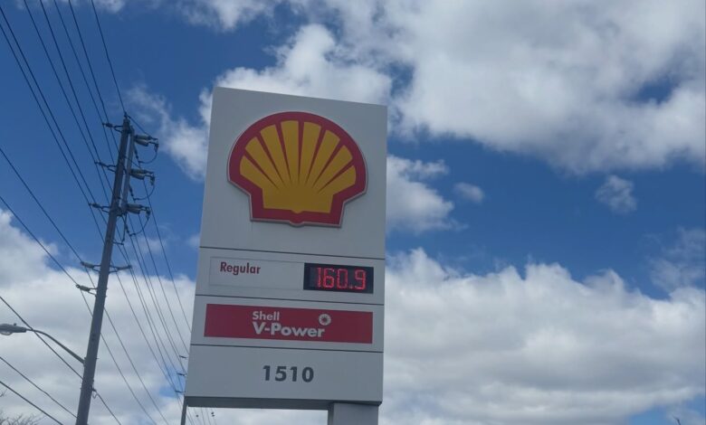 Shell gas station sign with the yellow shell logo, price board showing Regular $1.609 and a Shell V-Power panel.