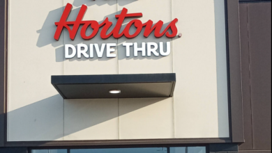 Tim Hortons Drive Thru sign on a storefront exterior with red logo lettering above the entrance