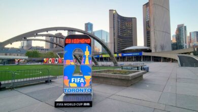 FIFA World Cup Toronto display in an urban square with curved arches and modern high-rise buildings in the background.